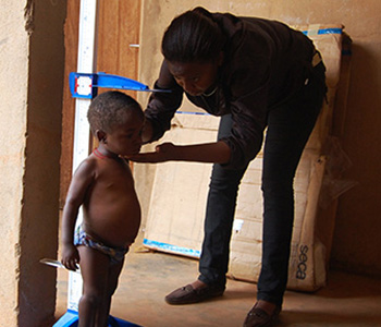 Woman checking height of child