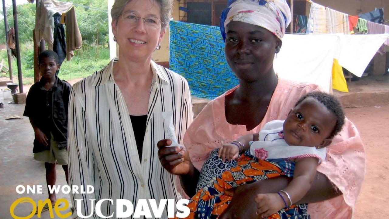 Distinguished Professor of Nutrition Dr. Kathryn Dewey (left) with mother & child from Burkina Faso