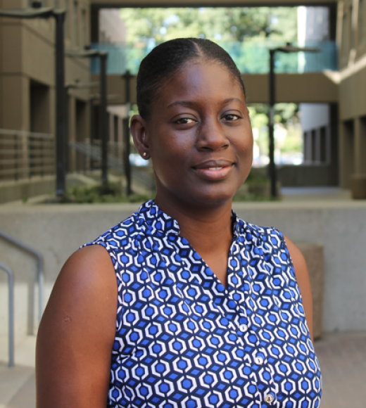 Sika standing in Meyer Hall breezeway, in blue & white circles sleeveless top