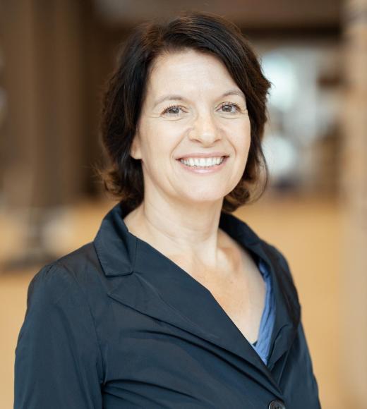Sonja Hess in navy blue button up jacket, smiling