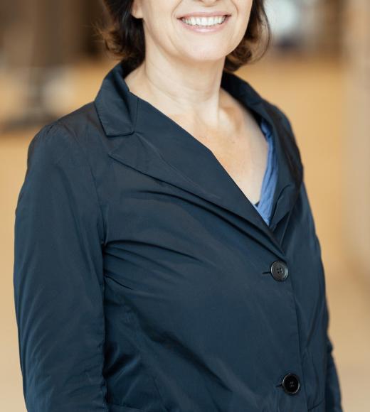 Sonja Hess in navy blue button up jacket, smiling