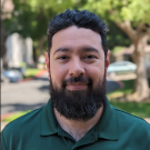 Jonn Fajardo headshot in green shirt outside