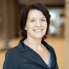 Sonja Hess in navy blue button up jacket, smiling