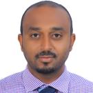 Biniyam Tesfaye face shot, purple & white checked shirt, navy blue tie