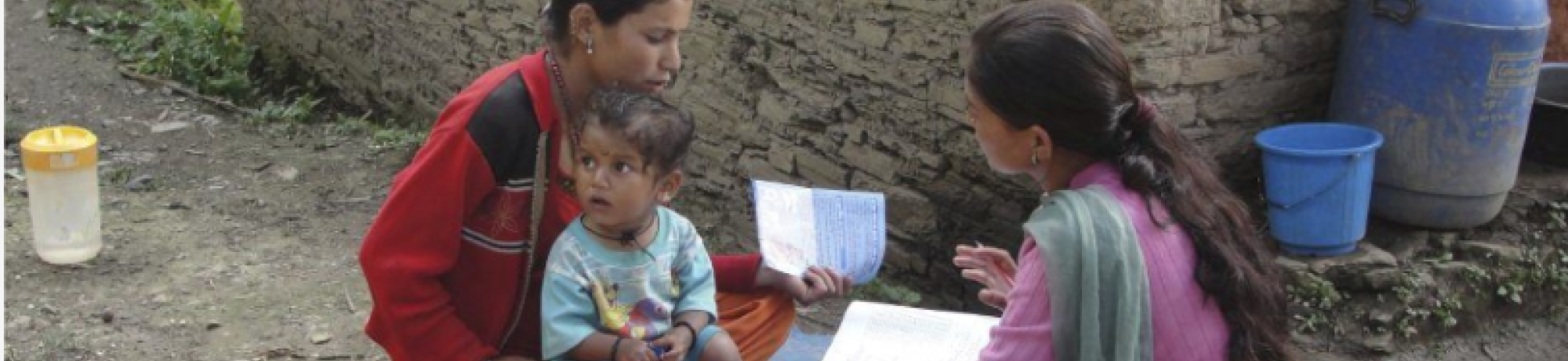  Bangladesh health worker interviewing mother with little boy in her lap
